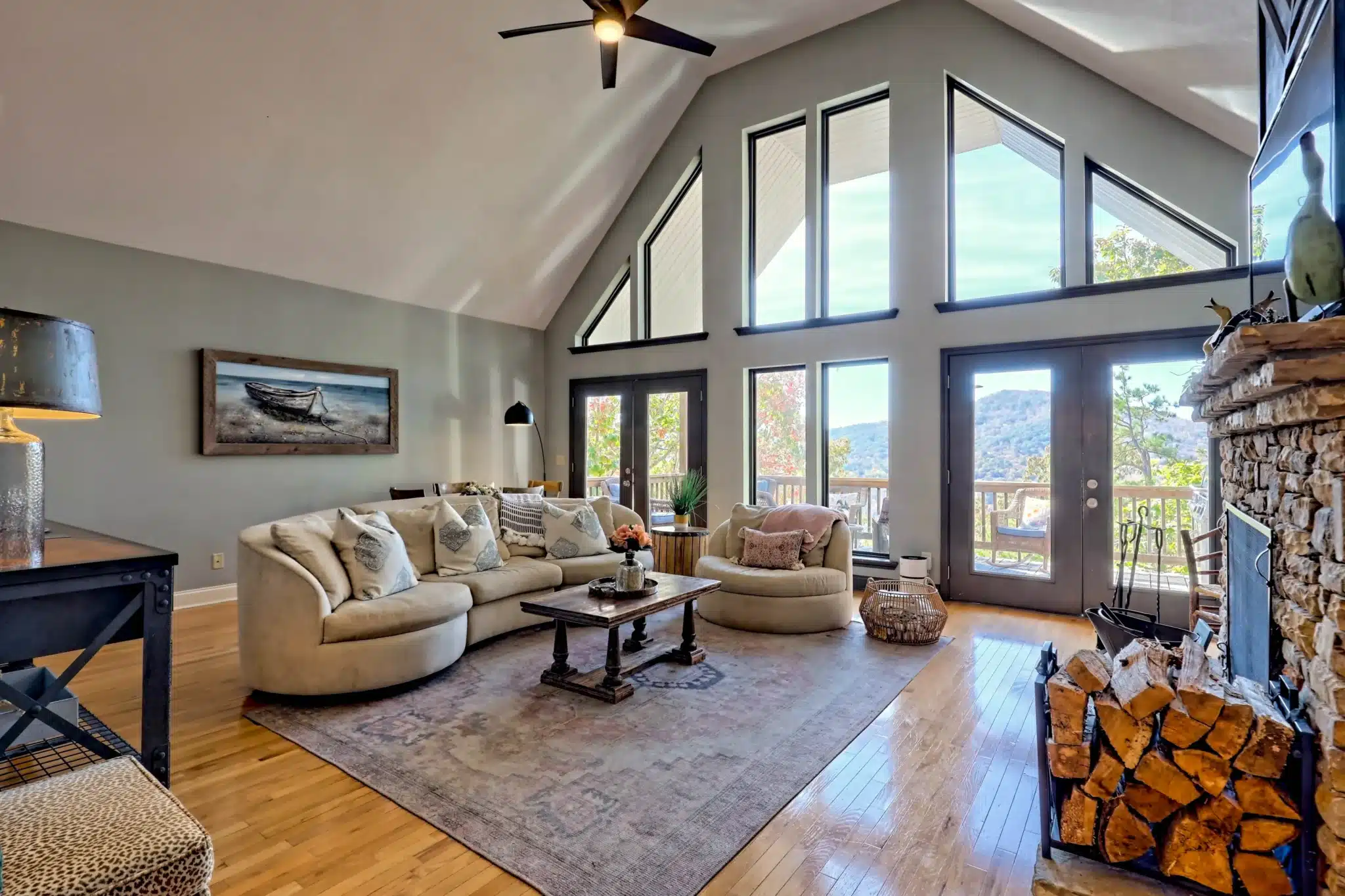 Vaulted living room at Sunset Ridge in Clayton, GA with stone fireplace and mountain-view windows
